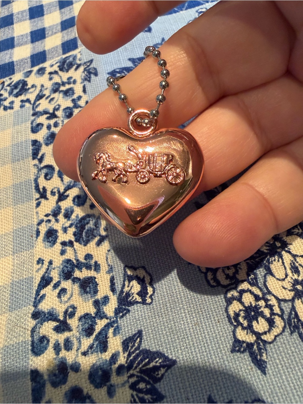 Coach Rose Gold Heart Locket Necklace with Carriage Motif.
